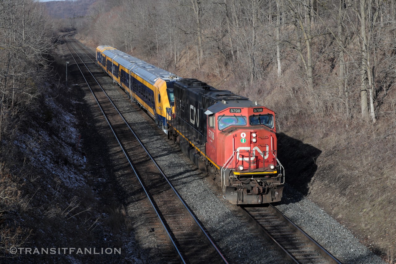 CN L27691 17 with CN 5708 on the point, Ontario Northlander TS2 (cab car 949-942-941-engine 940) in tow bound for VIA TMC, rushing through east end of Dundas sub towards Aldershot yard where Sarnia crew finished their trip and Aldershot crew will take over for the final miles on Oakville sub after MX passenger rush finishes the second day. (2026/03/18)