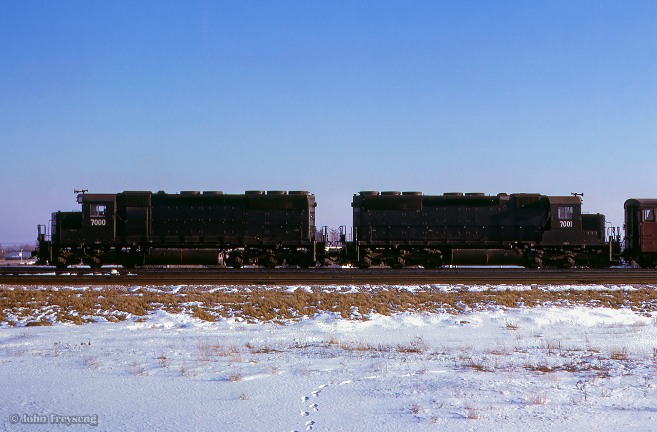 EMD SD40X demonstrators 7000 and 7001 are seen at CPR's Agincourt yard with dynamometer car 62, on the head of a freight from Calgary.  Temporarily renumbered while testing on CP, the units were built in 1965 as EMDX 434D (7000), and 434C (7001), part of a set of 8 units; 434A - 434H, sold to UP in 1966.

Scan and editing by Jacob Patterson.

Another view by Doug Hately HERE