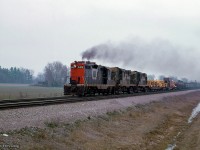 The hogger of CN Extra 4402 East has the throttle wide open getting his this train up to track speed through Speyside. 

<br><br><i>Scan and editing by Jacob Patterson.</i>