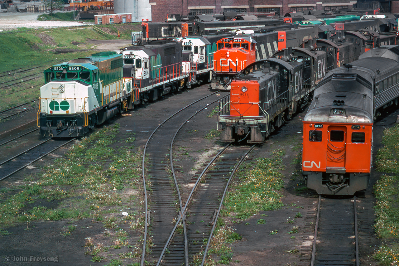 An assortment of power rests at CN's Spadina engine facility.  From left, GO Transit 9808, 9806, 9804, 980x, 9810, 980x, CN 9434, 5535, 4102, 8031, 1244, 1252, 125x, 1248, 6203.

Scan and editing by Jacob Patterson.
