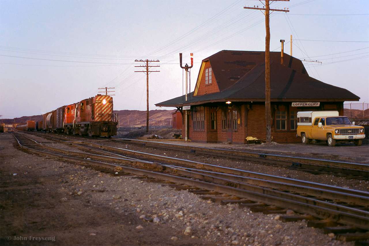A westbound wayfreight departs Sudbury on the Webwood Sub, passing the station at Copper Cliff.

Scan and editing by Jacob Patterson.
