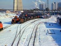 A large assortment of switchers fill the shop tracks at Spadina roundhouse, in the company of a few RDCs, a GP38-2W, and Tempo RS18m.  Note the turbo just poking out of Union Station.<br><br><i>Scan and editing by Jacob Patterson.</i>