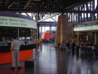 Passengers move through Ottawa's station, purchasing tickets, getting a meal at the restaurant, reading newspapers, magazines, waiting to begin their journeys.  CN 6518 idles in the distance.

<br><br><i>Scan and editing by Jacob Patterson.</i>