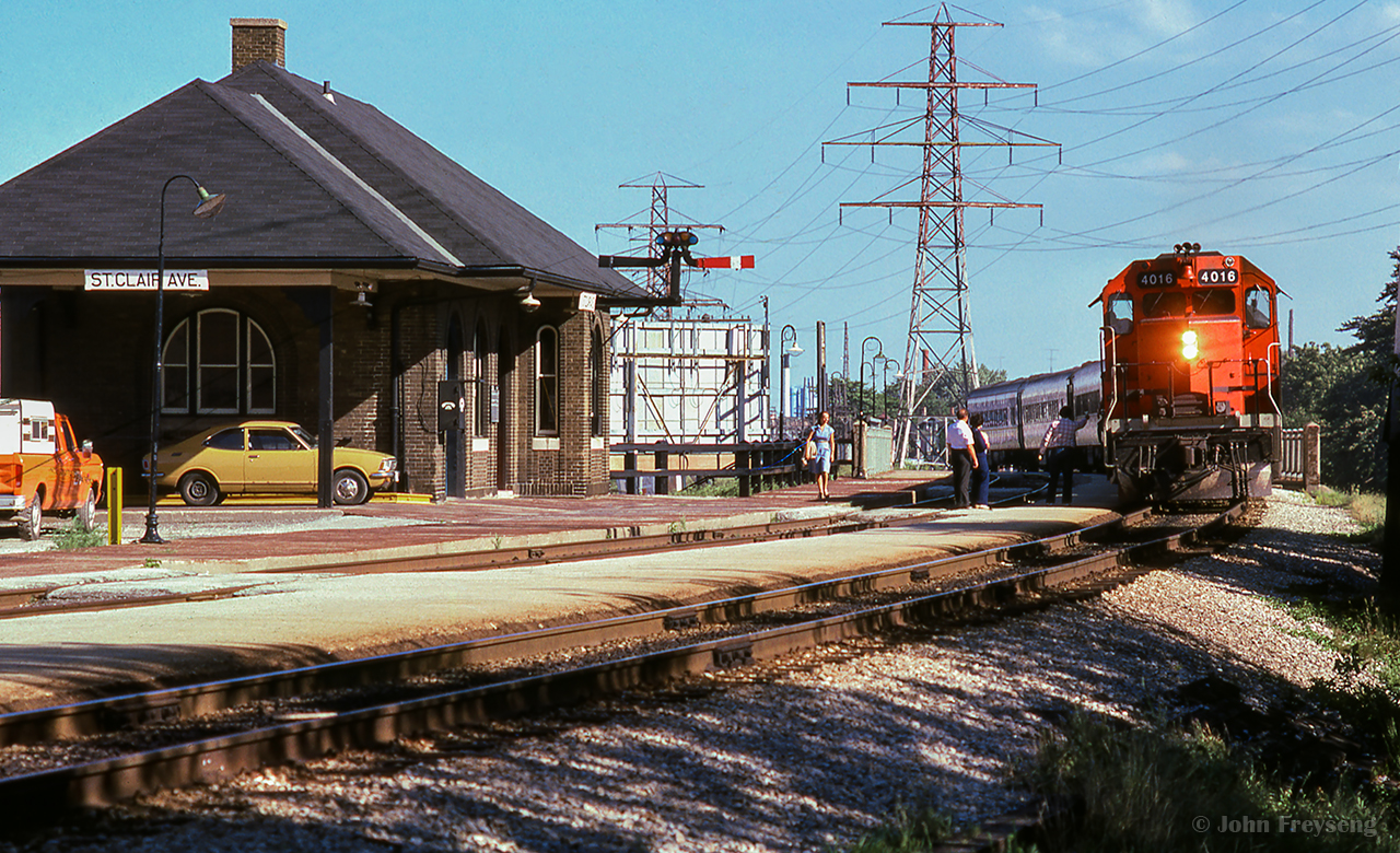 The operator is out on the platform at St. Clair Avenue, passing orders to the crew of train 169, the "Barrie Bullet."  The usual assortment of heavyweight equipment makes up the consist.

Scan and editing by Jacob Patterson.