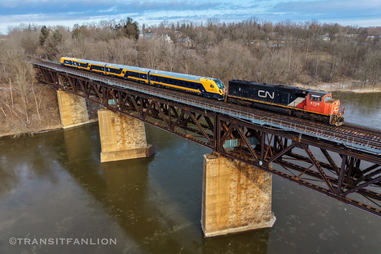 CN L27691 17 with CN 5708 on the point, Ontario Northlander TS2 (cab car 949-942-941-engine 940) in tow bound for VIA TMC, rushing through east end of Dundas sub towards Aldershot yard where Sarnia crew finished their trip and Aldershot crew will take over for the final miles on Oakville sub after MX passenger rush finishes the second day. (2026/03/18)