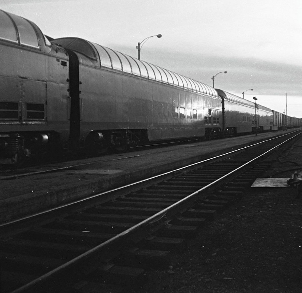 Back in 1964, CN purchased 4 full length dome cars from the Milwaukee Road. They are shown in Capreol, Ontario, marshalled ahead of the caboose, heading west to Transcona Shops in Winnipeg for refurbishing.