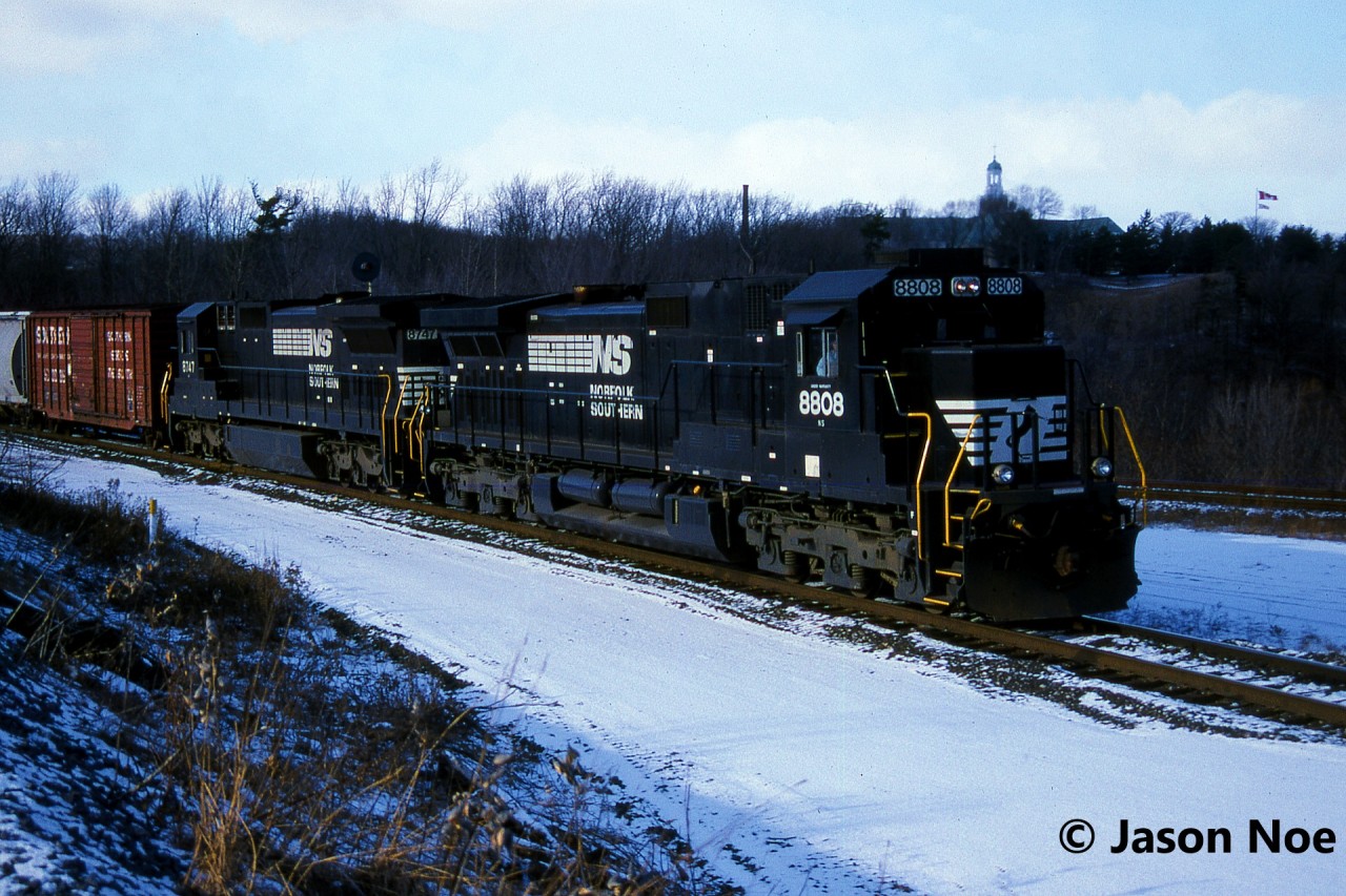 Norfolk Southern train 328 is viewed having just entered the cowpath at Hamilton West, Ontario as it completed its eastbound trip over the CN Dundas Subdivision and is now heading for the Grimsby Subdivision. Powering 328 are Dash 9-40C 8808 and Dash 8-40C 8747.