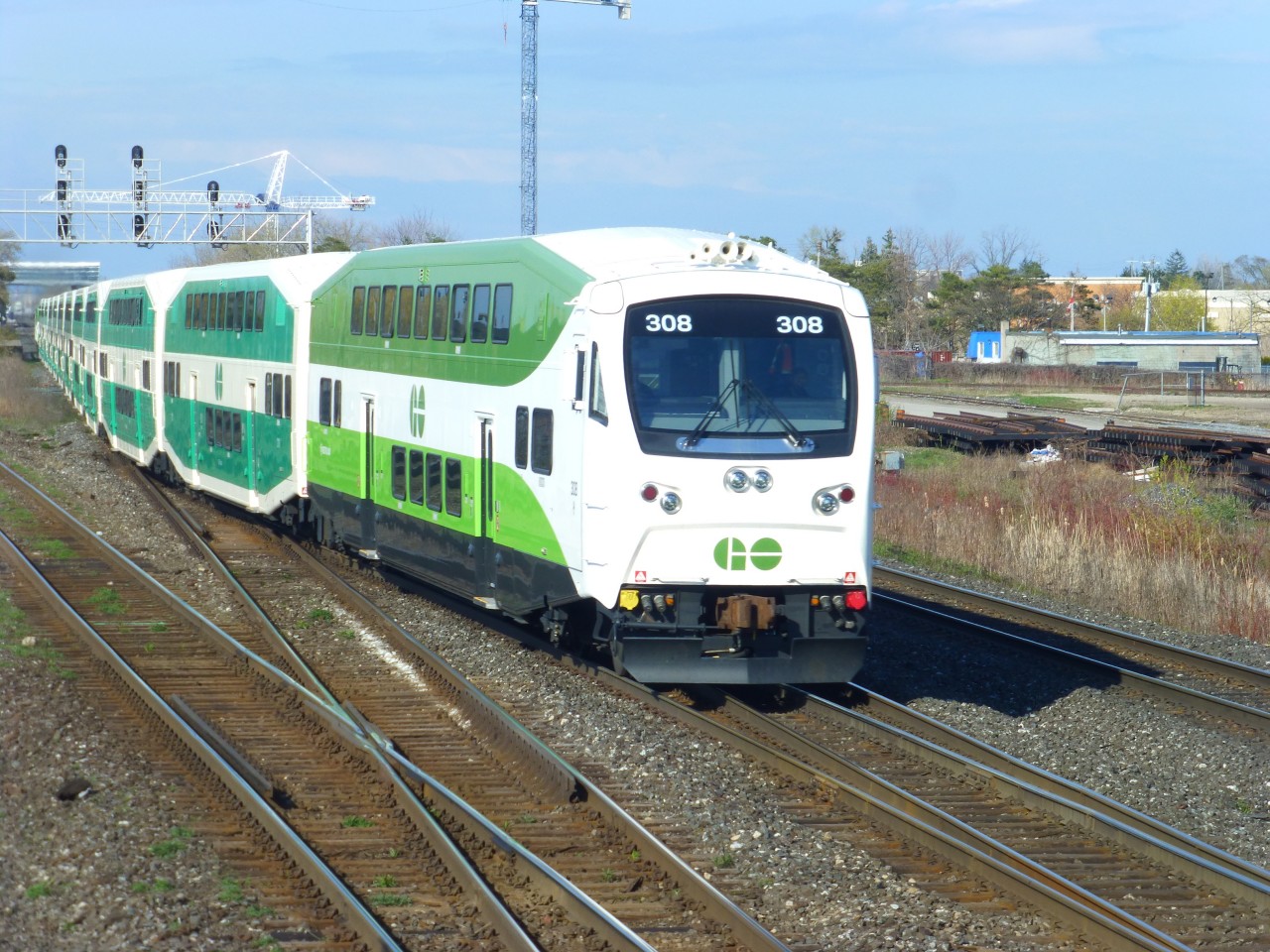 Westbound GO/Metrolinx cabcar #308 crosses over from #1 track to #2 track at Burlington West on CN's Oakville Sub.  The signal bridge in the background are the westward limits of GO/Metrolinx owned trackage. Meanwhile my eastbound freight train is moving through the crossovers as we head up the north track of CN's Halton Sub.