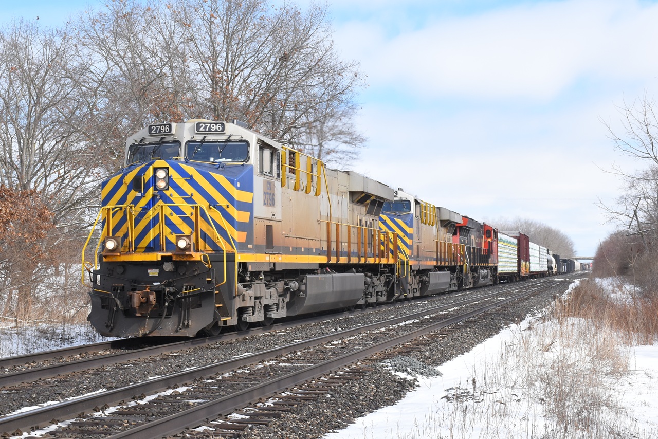 Planning to waste away another lunch hour at the station in Brantford, I was just about there when I heard a rumble and looked in my rearview mirror to see a blur of blue, yellow and silver whiz by. After some choice words, I decided to head for the highway and try to get ahead of the train west of Paris. The train slowed significantly on the westbound grade through CN Hardy, which was my saving grace. I figured I didn't have time to get to Paris West so I opted for a farm crossing at the end of Township Road 2. I got out of the car and crossed the track as the train rounded the slight curve at Paris West. I fired off a few photos, waited for the train to pass, hopped back into my car and made back to work and sat down at my desk at 1:00 p.m. on the nose. It sure wasn't the lowkey lunch hour I had anticipated! The ex. Citirail units seem to be showing up more regularly lately, providing a little bit of variety.