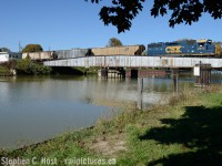 The last CSX Train (to date) is reversing across the C&O Drawbridge over the Sydenham River in Wallaceburg complete with it's C&O markings. Not only was this the last CSX Train to Wallaceburg, the C&O Built (Typical of them per Bruce Mercer - cheap cinder block construction) RTC office pictured at left also closed on this day with the line changing to rule 105 territory on the 3'rd. By this time the CSX dispatchers were all consolidated in Jacksonville except for this tiny office, which also housed the Bridgetender's office. The bridge tender would have to come down from Sarnia to operate the bridge, joining the dispatcher for a visit prior to the train's arrival and to ensure the bridge was properly closed and safely secured for trains to pass over. The Region of Chatham-Kent bought the line the next day and has since sold it to a numbered company - the rails are still in place, but it will cost millions to bring the line back to service and 13 years later as I write this, nothing has operated south of Sombra since. The track from Dresden south to Chatham also hasn't seen a train since 2006 and is also still in place. What do you think the future holds for this line? I'd love to see another train and this is NOT the last train to Wallaceburg. Add a comment below to add what you'd like to see happen. <br><br> Bonus: Let's go back into the white C&O cinder block Dispatchers office again.<a href=http://steve.hostovsky.com/clear43.mp3>RTC asks a train to clear track for the next northbound where they clear mile 43.</a> then this happens <a href=http://steve.hostovsky.com/clearance_nine_north_chatham_wallaceburg.mp3>Clearance nine</a><br> Audio recorded July 15 2005, back when the Sarnia division had about 60-80 employees on the payroll and started 8 to 10 crews per day. Now they have about 6-7 employees and run 1 to 2 crews per day. Sigh.  <br><br> If you are interested in more recordings, check out <a href=http://www.railpictures.ca/?attachment_id=23404 target=_blank>This pic at Whitebread</a> and <a href=http://www.railpictures.ca/?attachment_id=25773 target=_blank>More wallaceburg</a> and you just might find more photos. I've posted more than half of my stuff from this line, but still more to come!