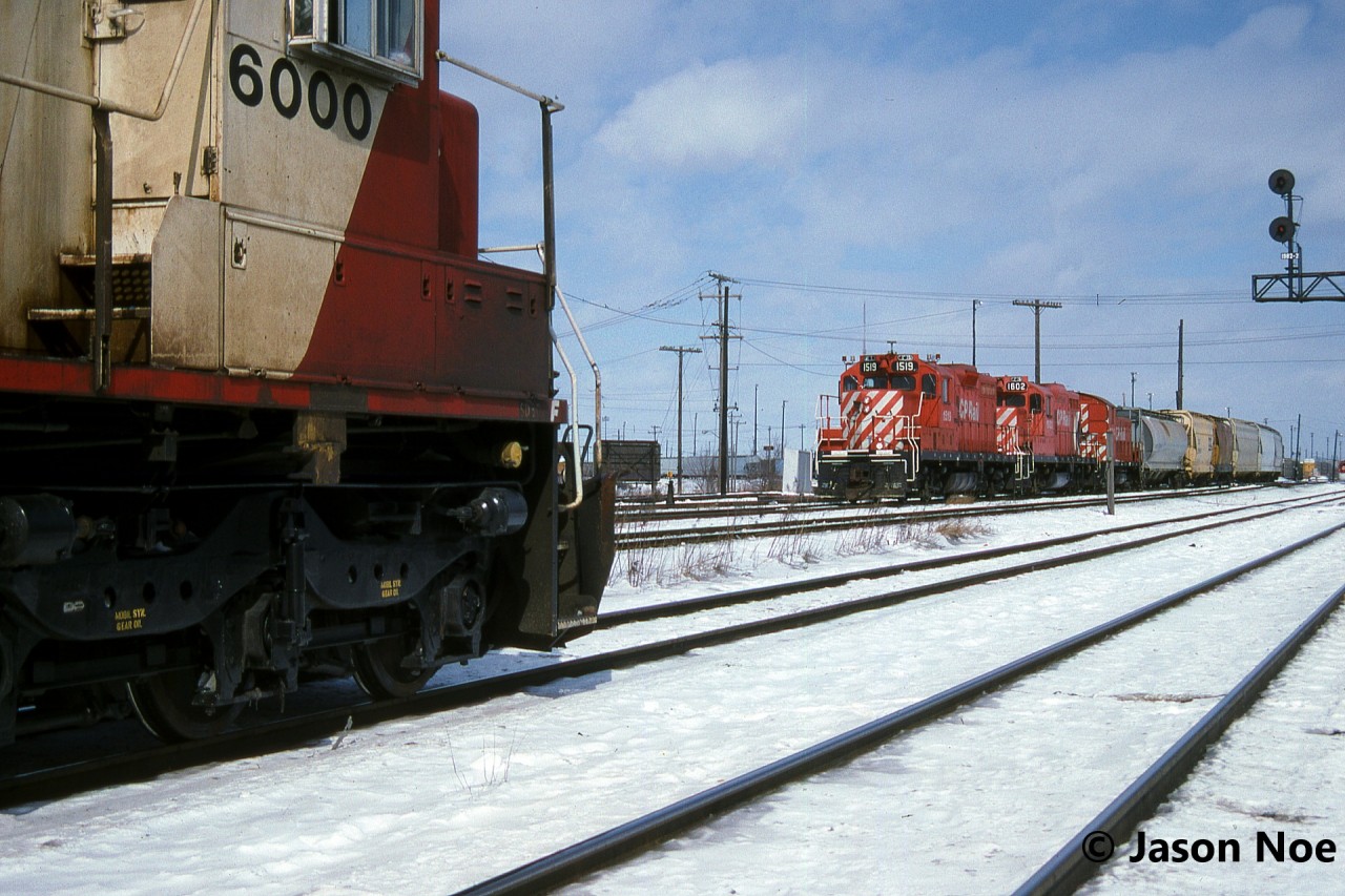 SOO Line SD60 6000 patiently waits to enter CP’s Toronto Yard in Scarborough, Ontario and meets a hump set heading out with another cut of cars to sort. The train had previously come off the MacTier Subdivision at West Toronto and had SOO 6000, HATX 513, MRL 222, 5821 and 5610, while the hump set had 1519, 1602 and 6713.
