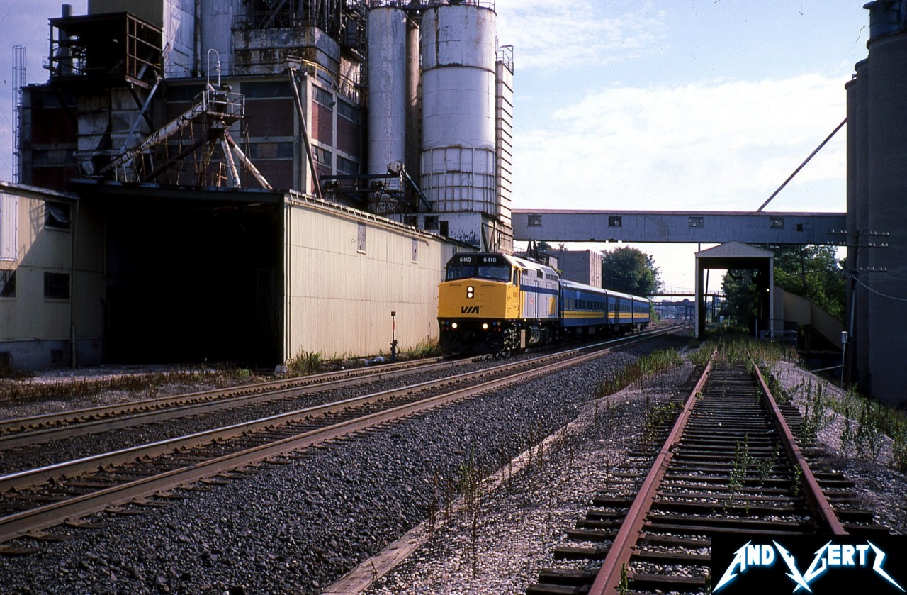 VIA Rail train 71 with 6410 is captured beneath the large Purina/Cargill plant in Woodstock, Ontario as it heads westbound to London and Windsor on the Dundas Subdivision. As of this winter, this agricultural milling facility was in the process of being torn down.