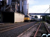 VIA Rail train 71 with 6410 is captured beneath the large Purina/Cargill plant in Woodstock, Ontario as it heads westbound to London and Windsor on the Dundas Subdivision. As of this winter, this agricultural milling facility was in the process of being torn down. 