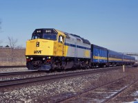 F40PH-2 6411 leads VIA No. 73 away from its stop at Aldershot early in 1995. The former CN "blue cars" and steam generator are rolling off some of their final miles; within a year, head end power ("HEP-2") stainless steel will replace them on Toronto-Windsor trains. (At the time of the photo, HEP-1 cars were normally used on the Niagara Falls trains.)