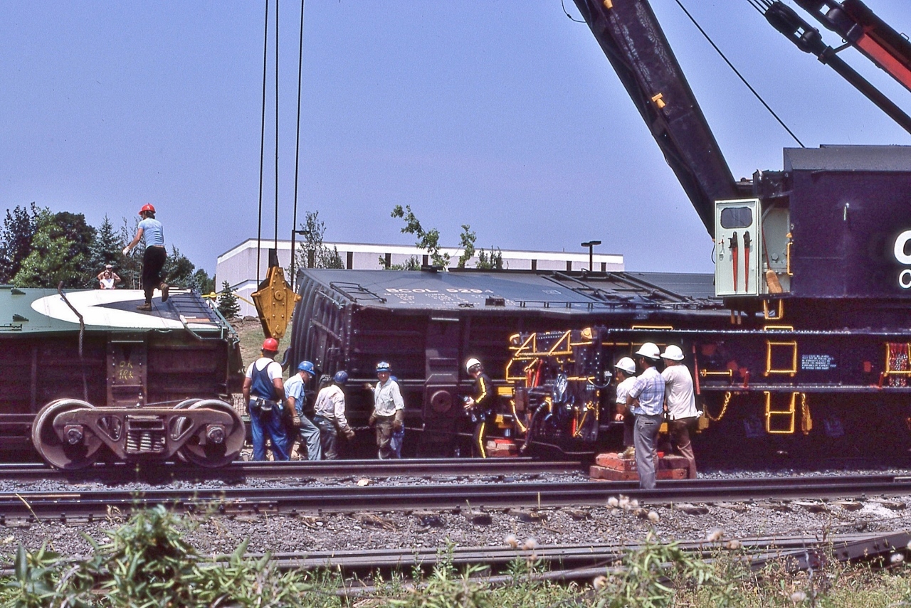 The Toronto Auxiliary CP Rail 414501 is cleaning up a couple of paper product boxes,


At CP Rail Don Mills crossovers mile 204.1 Belleville Sub., July 1987 Kodachrome by S.Danko


 More


   primer Hi Rail 


CP Rail 414501 is  a 250 ton capacity wrecking crane serial 11729 built 1946 by Industrial Brownhoist, now at St. Constant PQ (thank you Paul O'Shell).


sdfourty