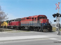 On a pleasant spring day in April 2006, GEXR 432 heads east out of Kitchener, crossing Bingemans Centre Dr., with RLK 4096-GEXR 4019-GEXR 4046 for power.