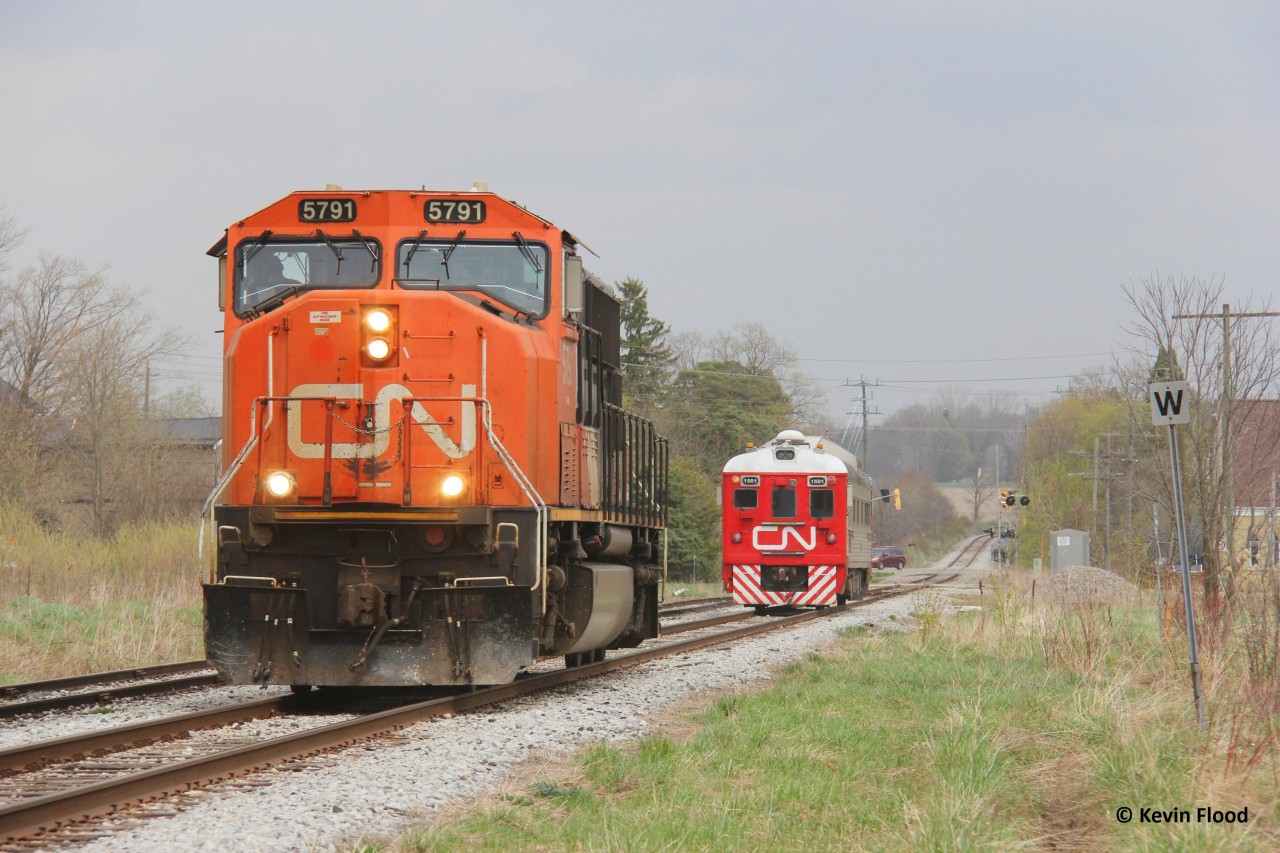 The CN test train, which typically runs as CN 1501 solo, was equipped with a 6-axle unit (same as when they were operating in 2024). The train ran east to Kitchener with the 5791 long-hood forward. It did not proceed east from Kitchener. Instead it went back west. The original plan was to put the 5791 on the other end of the RDC at Kitchener yard but the crew couldn't get a hold of 568, which was working the yard at the time. Instead they went as far east as Sturm and then went back west, utilizing the rarely used siding track at Baden to move the engine so it was nose facing west. Meanwhile, the sun begins to fade from incoming thunderstorms on this warm late April day.