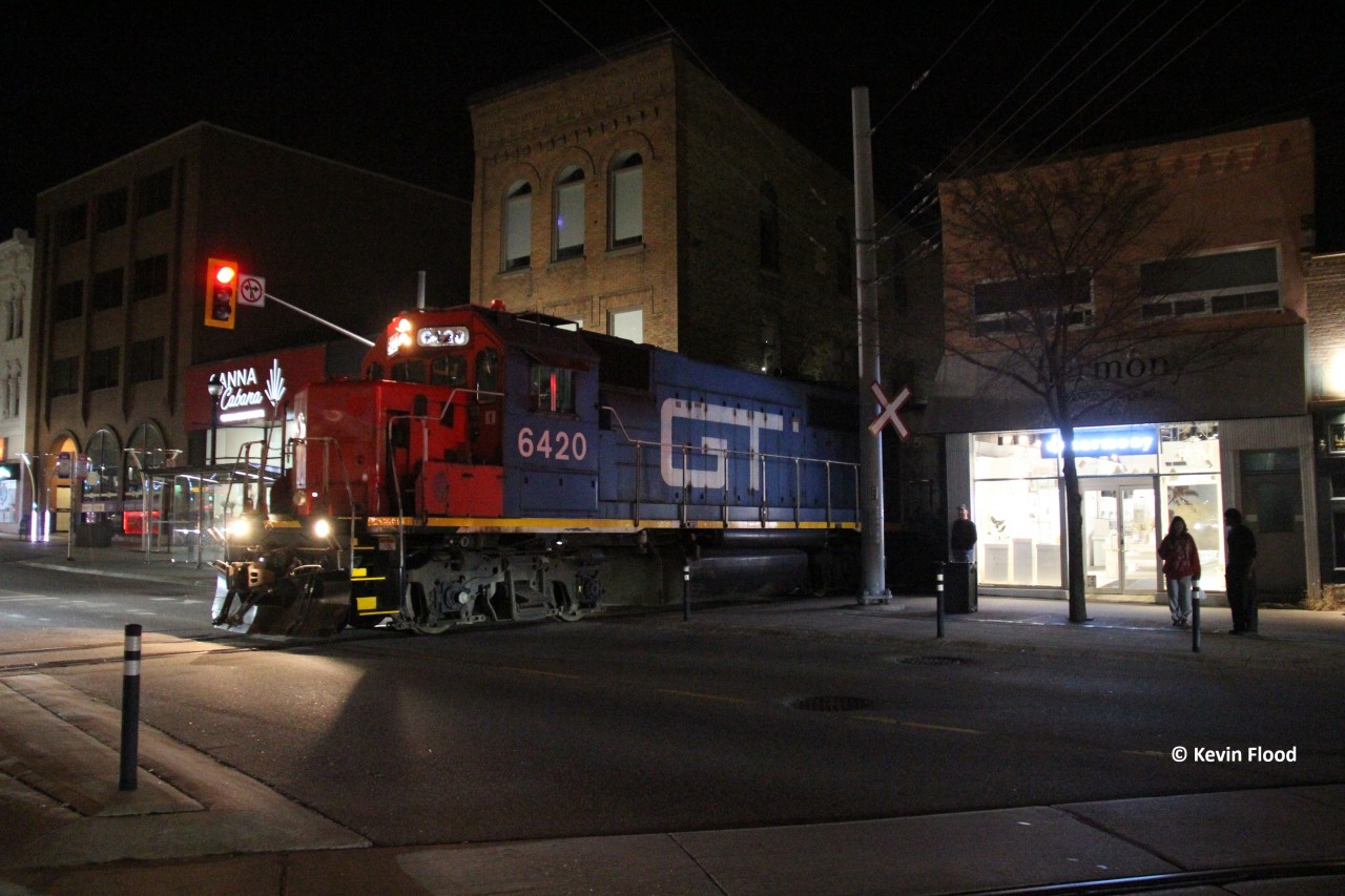 CN 566 creeps across King St. in Uptown Waterloo on a Friday evening with GTW 6420 and CN 9555 for power. After this point, it will pick up some speed and make its way to Elmira for its usual work. CN 566 is typically a M-W-F evening train and typically goes up between 22:30-00:30.