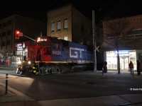 CN 566 creeps across King St. in Uptown Waterloo on a Friday evening with GTW 6420 and CN 9555 for power. After this point, it will pick up some speed and make its way to Elmira for its usual work. CN 566 is typically a M-W-F evening train and typically goes up between 22:30-00:30. 