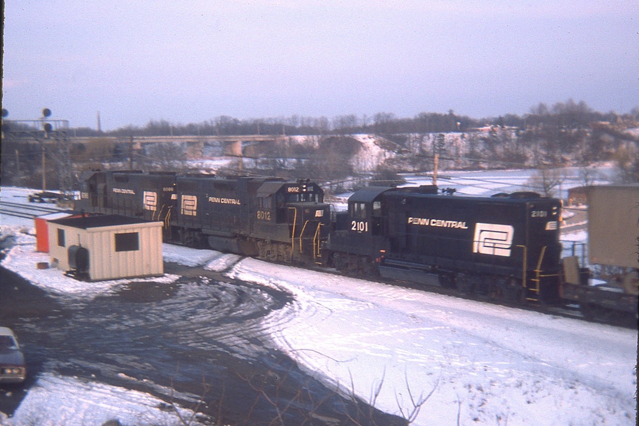 Late afternoon Toronto-bound Penn Central power on what I figure was the TH&B Starlite (I've forgotten)  rolling thru Bayview as seen from up on the hillside.  Units are PC 8086, 8012 and 2101. The paint looks relatively new on the 2101, which I think is a GP20. Info on this loco would be appreciated.