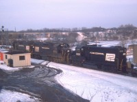 Late afternoon Toronto-bound Penn Central power on what I figure was the TH&B Starlite (I've forgotten)  rolling thru Bayview as seen from up on the hillside.  Units are PC 8086, 8012 and 2101. The paint looks relatively new on the 2101, which I think is a GP20. Info on this loco would be appreciated.