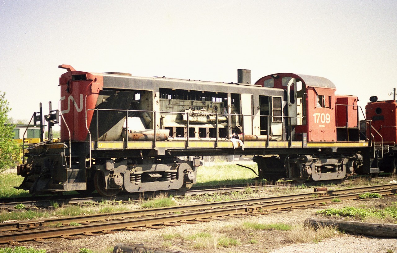 When I got into this hobby, these locomotives were nowhere to be found.........except in a scrap line. At least this photo is better than nothing.  Here is MLW RSC-13 #1709 pretty much cannibalized and waiting out the scrapper at the London East reclamation yard. And yes, I got a souvenir. One lone bolt. :o)