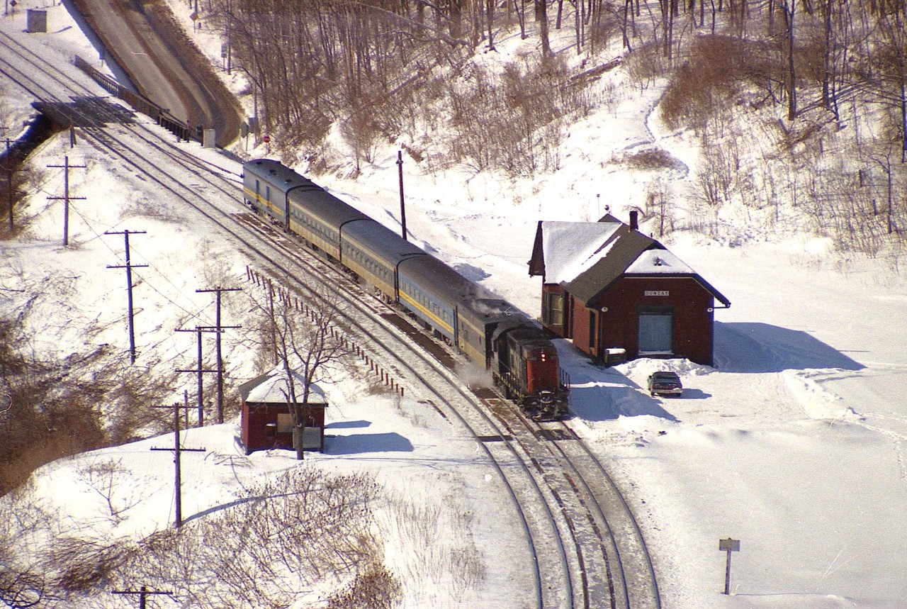 Back when I was young(er) and more adventurous, I would wander up to the lookout at Dundas Peak and wait for some trains to record with my old Pentax 1000. I'd not do this trek any more; too damn lazy; but these days the area is pretty much off limits and even hiking to the Peak requires paid parking and I think controlled hours.
In this morning view we see CN 3105 east; I have distorted this image, unfortunately, shooting full out 210 MM with a cheapo lens but at least caught the memories.
It is a long time back but I know I made the hike because that is my car parked at the Dundas station.