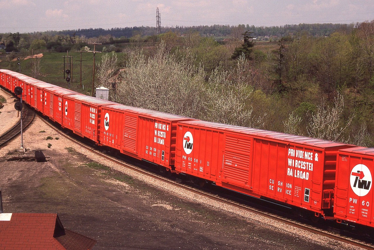 Not often you see anything as bright as this coming down the pike !!  A slew of new boxcars for the Providence and Worcester heading eastbound on the CN.  Impressive!!