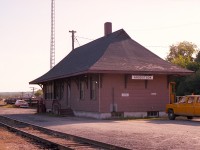 Aroostook was once a busy village. Situated near the Maine border, a station stood near the junction of the New Brunswick Railway (NBR) and the Aroostook Valley Rwy (AVR) connection. Now, the station, supposedly protected by Heritage; sits forlorn amongst the trees and shrubbery next to a trail; with only a fence to protect it from the elements.  The trail is the result of the track being lifted about 30 years ago. Hopefully this old frame structure, built in 1906, will see an honest effort to save it from slowly succumbing to the passage of time.