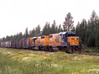 Rather overcast morning but at least there is lots of colour in the trackside growth as ONR 1805 and 1735 with a string of boxcars make their way to the pulp and paper company in Iroquois Falls.