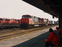 With CN having a rather nasty derailment north of Capreol on their Ruel Subdivision, a few of their trains were rerouted over the CP.
In this image, CN 2612 and 2577 are westbound while a CP crew watches the move from the bench in front of the station.
In the background is CP 'Barn" 9001. I never did get a decent shot of it.