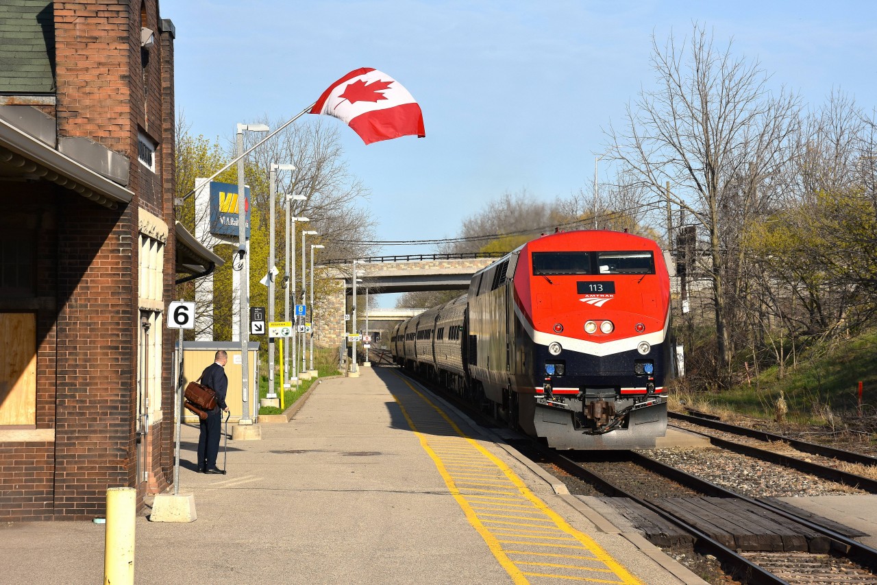 It certainly isn't very often I take a liking to Amtrak equipment. However, their #113 has been painted into a very attractive new scheme, and for those who do not see Amtrak very often this image will prove someone was on the ball in  coming up with such a striking design.
The train is shown slowing up at St. Kitts station for one passenger to board for Toronto. The flag is a nice touch to the scene.
Amtrak's "Maple Leaf" runs between New York City and Toronto daily.