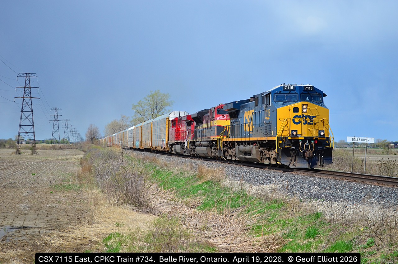 Mixing it up....  CSX CM44AC #7115 leads CPKC Train #734 past the Belle River mile board just east of Belle River, Ontario on April 19, 2026.  Been quite a while since I've seen a CSX lead on the CP around here, let alone even bother to go out an shoot anything, but this colorful lashup got me out for a bit.  About 10 minutes prior to this shot being taken it was dark and snowing!!!  Guess April 19th was just full of unexpected things.....