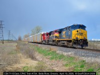 Mixing it up....  CSX CM44AC #7115 leads CPKC Train #734 past the Belle River mile board just east of Belle River, Ontario on April 19, 2026.  Been quite a while since I've seen a CSX lead on the CP around here, let alone even bother to go out an shoot anything, but this colorful lashup got me out for a bit.  About 10 minutes prior to this shot being taken it was dark and snowing!!!  Guess April 19th was just full of unexpected things.....