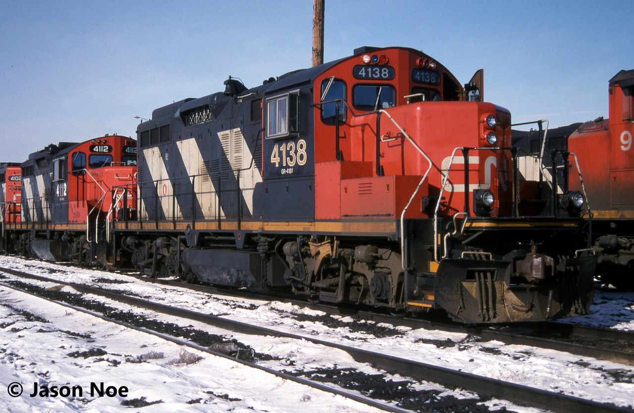 CN GP9RM 4138 along with 4112 and 4102 are pictured waiting for their next assignments at the MacMillan Yard diesel shop in Vaughan, Ontario. In the future, 4138 would be re-lettered AR Illinois for a starring role in the 1997 Canadian comedy “The Wrong Guy” that was filmed primarily around Toronto and area. Almost three decades later and the unit still retains it’s now fading AR Illinois logo on the nose.