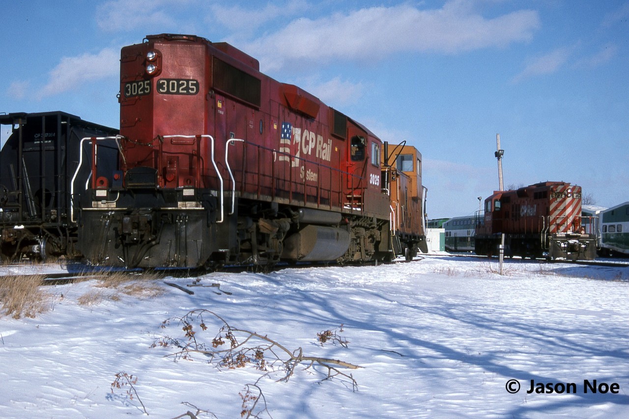 During a Saturday evening, CP GP38-2 3025 and caboose 434551 along with GP9u 8235 wait for their next week’s assignments at Guelph Jct in Campbellville, Ontario. On this day, CP caboose 434669 was also in the yard at the junction.