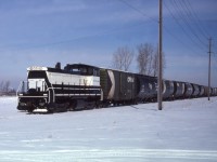 Pictured is ETR 107 with an impressive cut of cars, date is a rough estimate, ETR 107 acq. 7/1977 (ex DD-GM 113, nee EMD 113) SW1500 EMD 37436 4/1971.

Note the CNR Cylindrical hoppers in the back on the left. 

From Old Time Trains: This unit had been a plant switcher first at EMD in La Grange and later at GMD in London.
It had problems with the sharp curves in the GMD plant and was swapped for ETR 102 an SW8