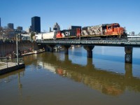 CN 500 is entering the port of Montreal with CN 4722 & CN 4761 for power. The engines are reflected in the high waters where the Lachine Canal empties into the St. Lawrence River.