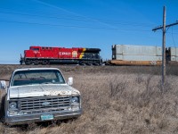 A fresh CPKC motor leads train 103 past some Saskatchewan "scenery" at Uren SK. 