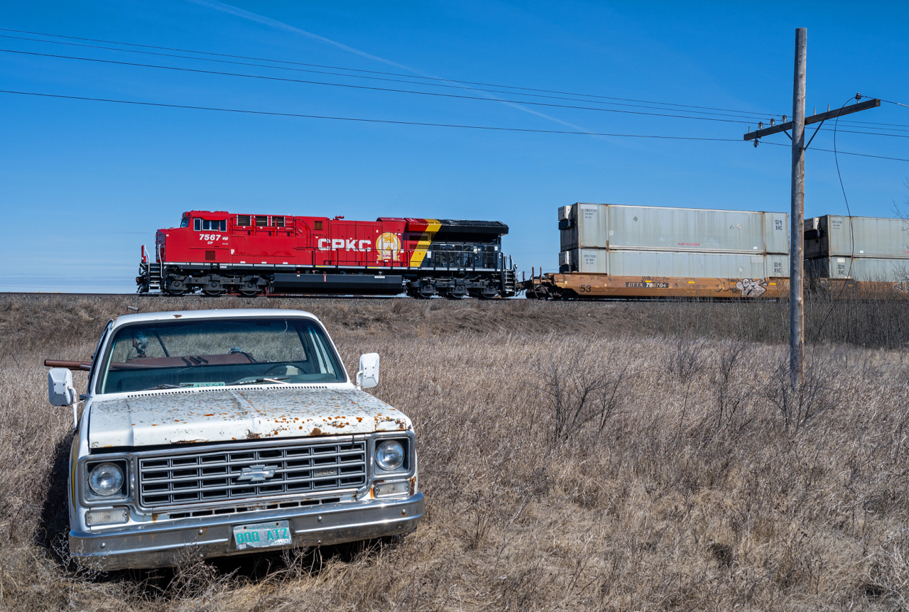 A fresh CPKC motor leads train 103 past some Saskatchewan "scenery" at Uren SK.