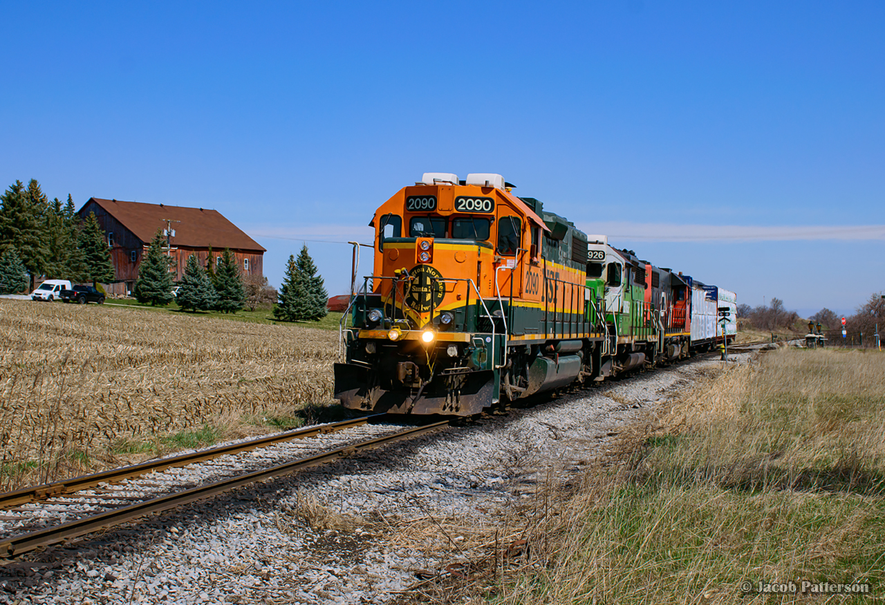 The sunny weather and colourful set of units brought a hoard of foamers out this day.  Bobbing by the farm at mile 26 of the Fergus Spur, 540 cruises down to Gillies Lumber.