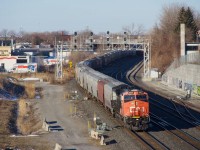 Decently clean CN 3027 leads grain train CN 878 on its way to the Port of Montreal on a sunny but cold morning.