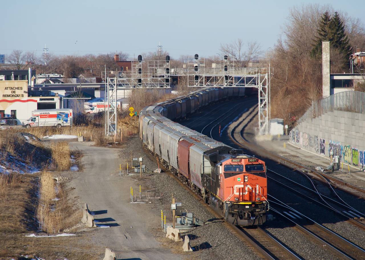 Decently clean CN 3027 leads grain train CN 878 on its way to the Port of Montreal on a sunny but cold morning.