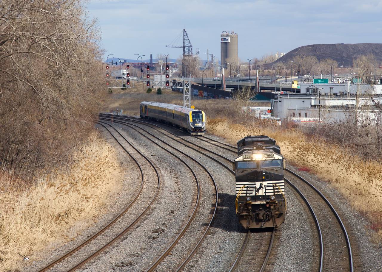 CN 543's light power and VIA 637 are both westbound in Montreal West. CN 543 has the common NS power and is returning from the Port of Montreal after bringing a grain train there.