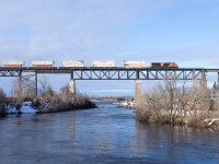 CN Z115 is lead North across the CPKC Bridge in Parry Sound Ontario behind CN 3889.