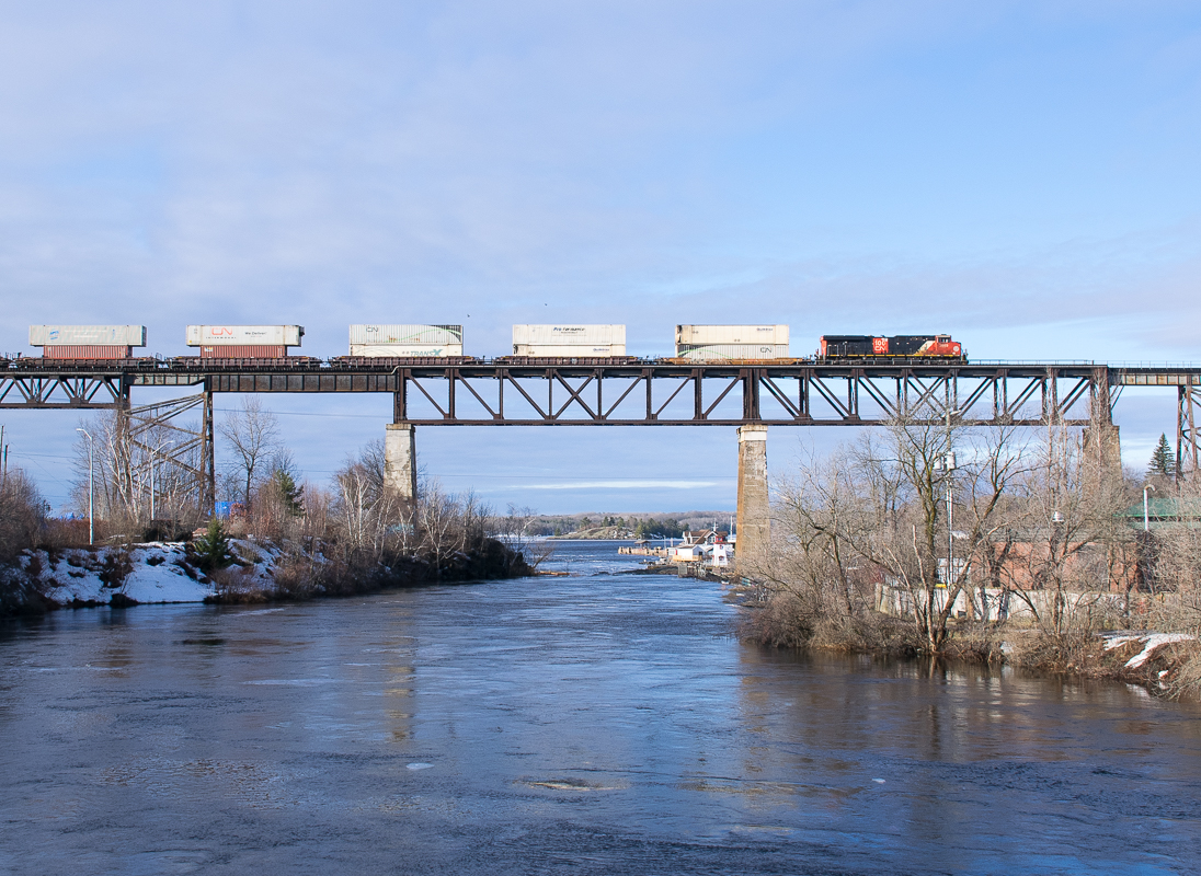 CN Z115 is lead North across the CPKC Bridge in Parry Sound Ontario behind CN 3889.