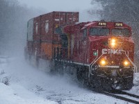 CPKC 113 is lead North at Rousseau Road by CP 7570 as a heavy snowy squall enveloped the area.