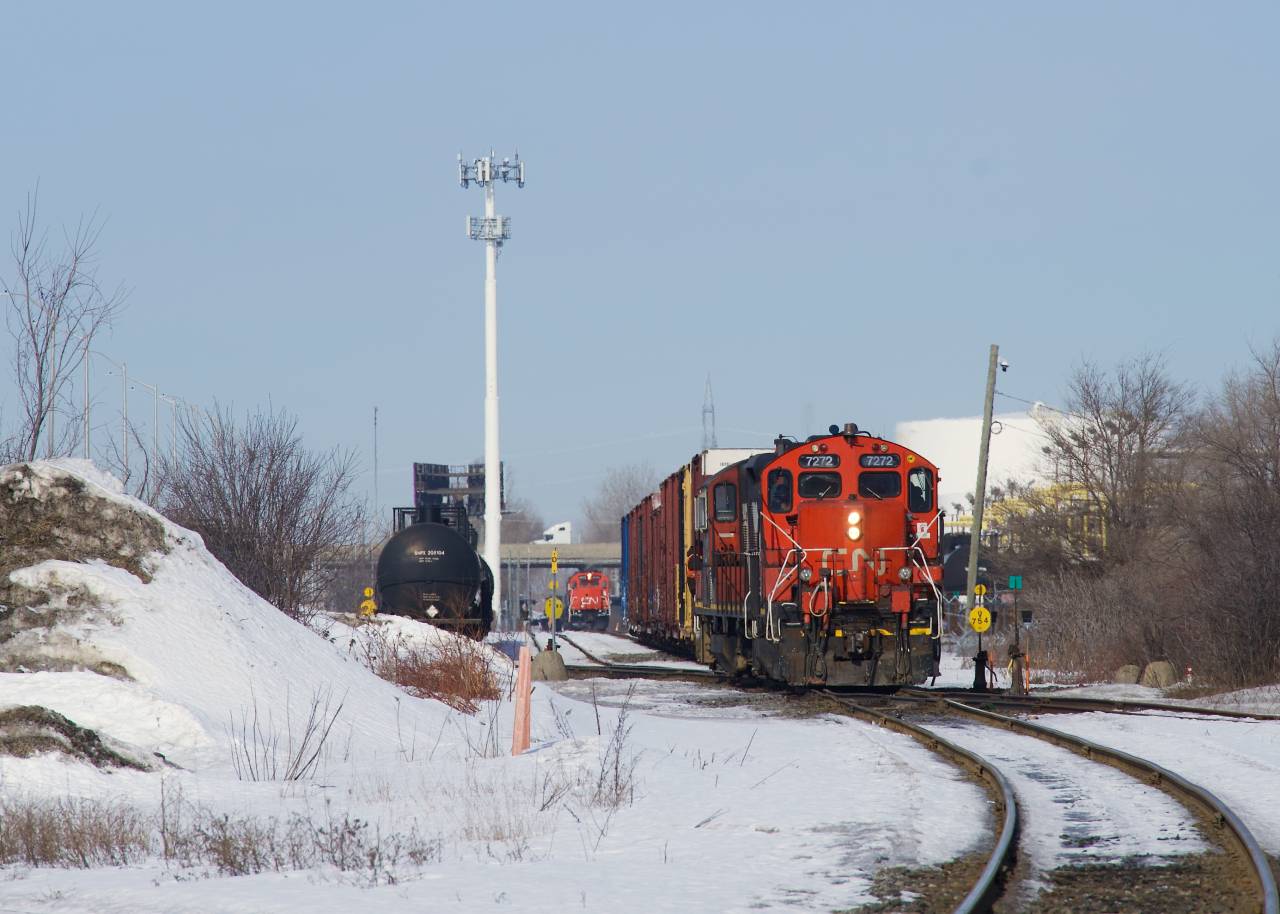 CN YRP002 with CN 7272 leading has just set off tank cars in Carrière Yard as CN 593 lurks in the background.