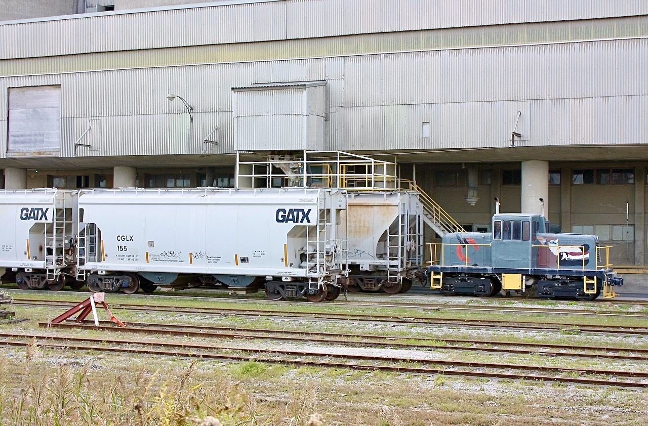 This was the only time I saw this centre cab critter shootable. The shot was through the fence and today the weeds and bushes are too high on the other side of the fence to get any photos, not to mention the unit is rarely in an open space. This was St, Lawrence Cement’s Mississauga operation but now has been rebranded as Holcim. The plant is regularly switched out by CN with the little swicher used to move cars around only inside the facility.