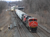 A Toronto-bound manifest train ID not known passes through Bayview Junction with an old -9wl trailing. In the background is a Toronto-bound GO train from Hamilton, taken in March of 2026 by Luka Borovcanin 